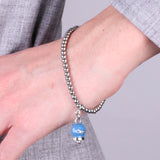Bracciale in Acciaio con campanella pendente blu cobalto con scritta Capri