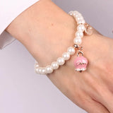 Bracciale in Metallo con perle e campanella portafortuna in smalto rosa con scritta Capri